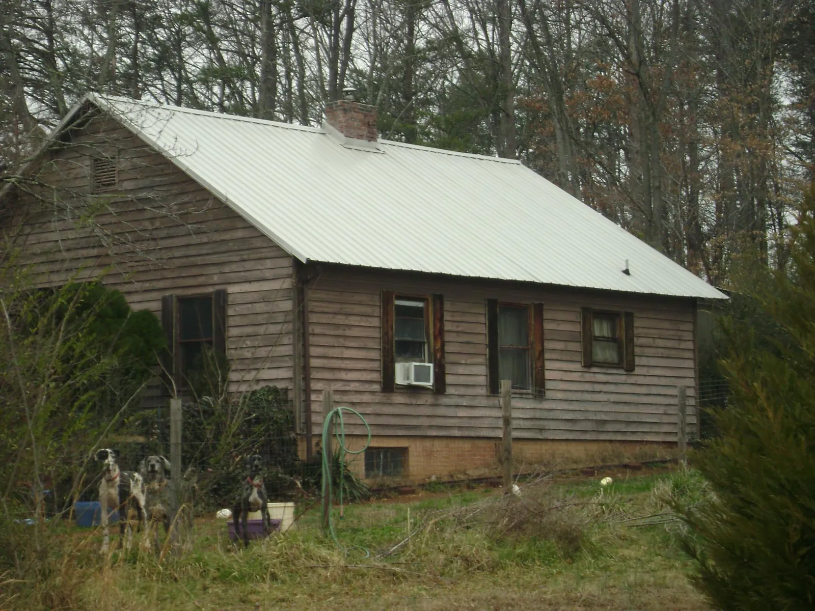 White metal roof on an old wood sided farmhouse, from a Metal Roof Installation job in South Royalton